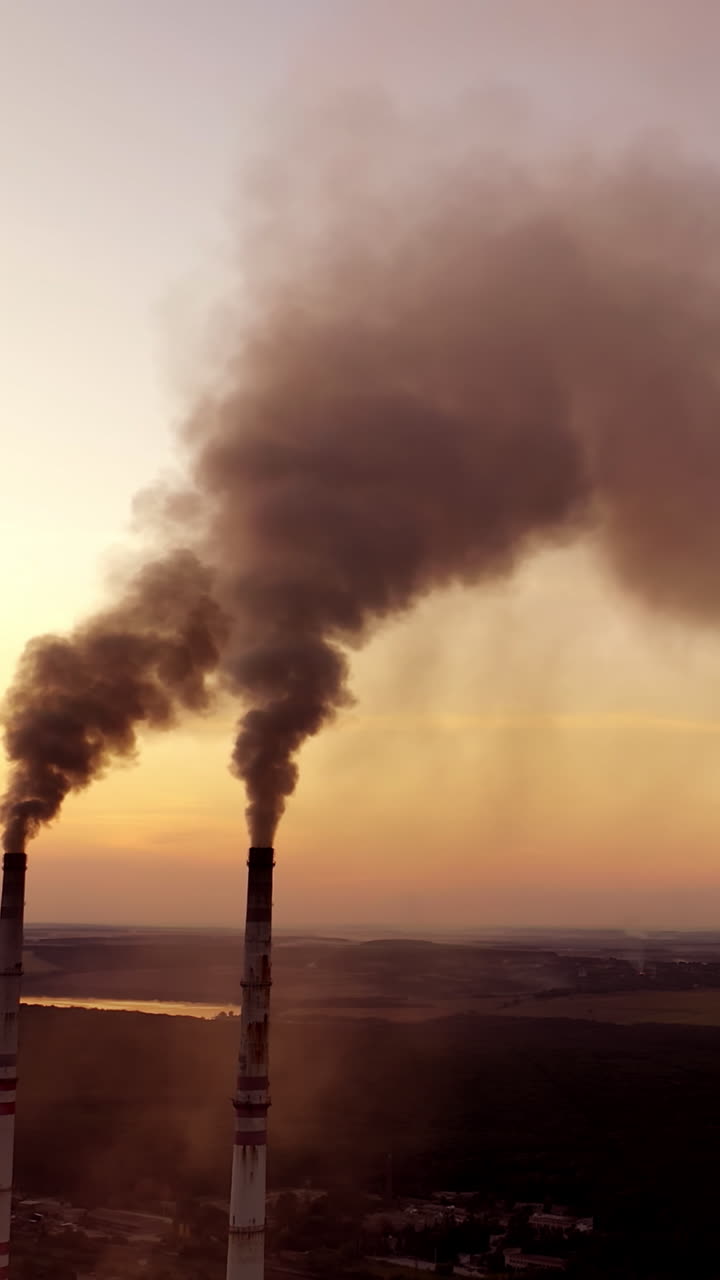 View of pipes with smoke. Landscape smoked polluted atmosphere from emissions of plant Vertical video