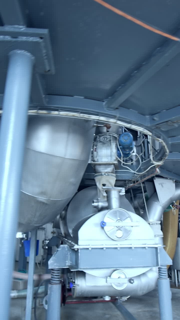 Modern technology of milk producing factory. Stainless diary industrial equipment. Vertical video