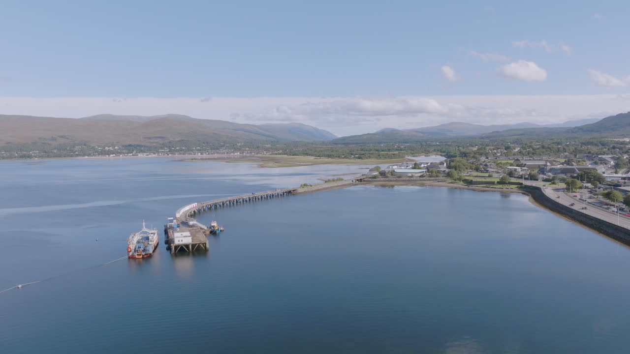 Fort William aerial reveal shot above Loch Linnhe near old pier looking north