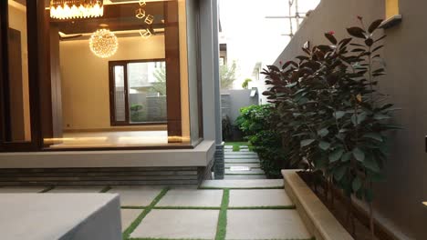 POV-Walking-Towards-Contemporary-Home-Courtyard-Outside-In-Karachi,-Pakistan