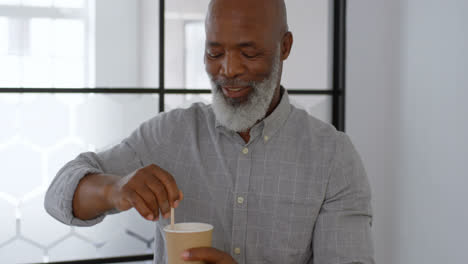 Businessman-stirring-coffee-at-office-4k