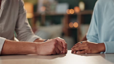 close-up of people holding hands for support and comfort