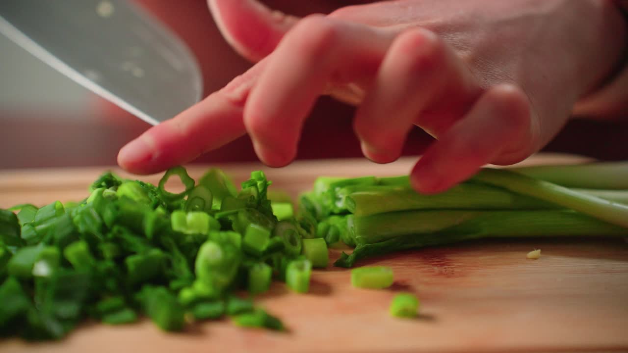 Cutting up green onion by hand with knife