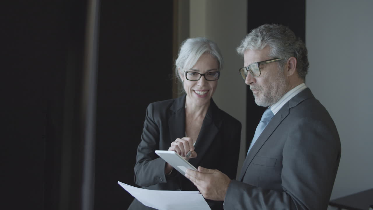 Mature male business leader consulting female expert