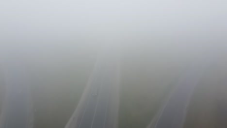 strong fog on the road aerial drone view