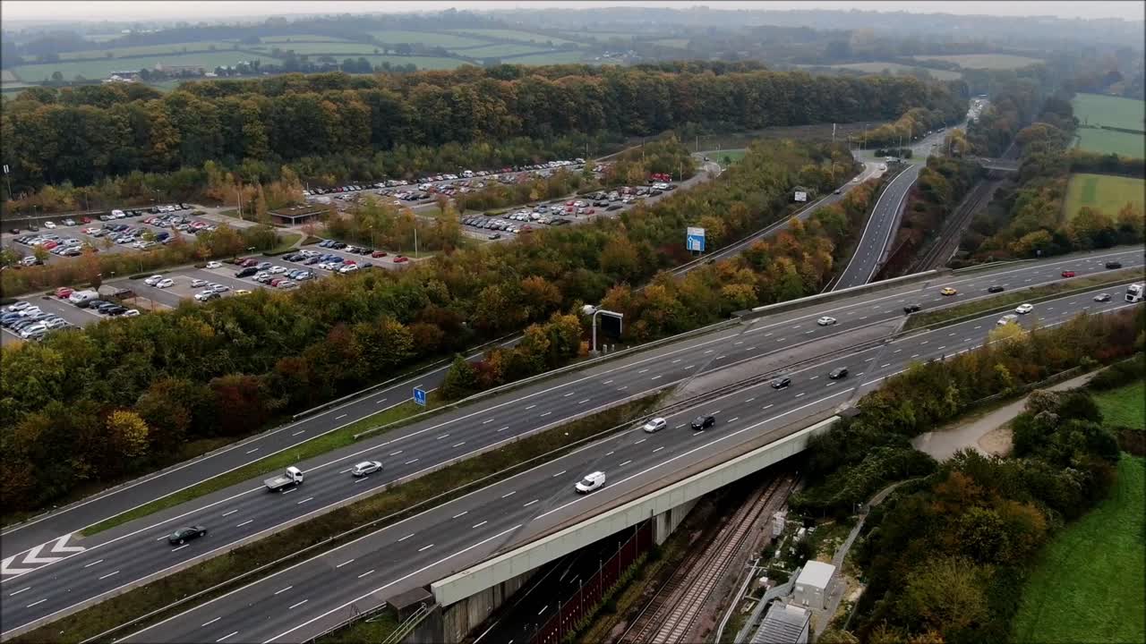 Aerial hyperlapse, timlapse of British motorway by drone. Busy, junction, transportation. Commuters