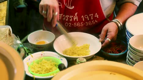 4k cinematic cooking footage of a thai chef preparing a dish of traditionnal thai food called khao soi in a restaurant in thailand