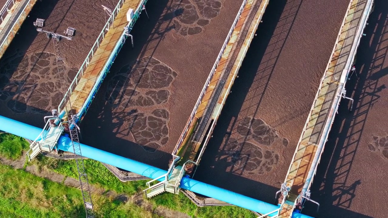 Brown wastewater bubbles through aeration basins at a plant in Liepaja