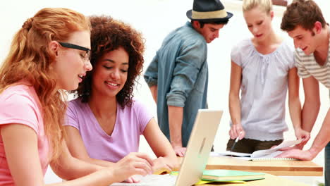 Smiling-young-students-all-working-together