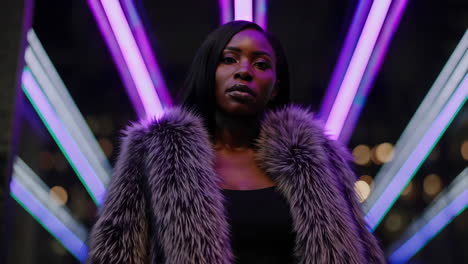 stylish woman in fur coat against neon lights