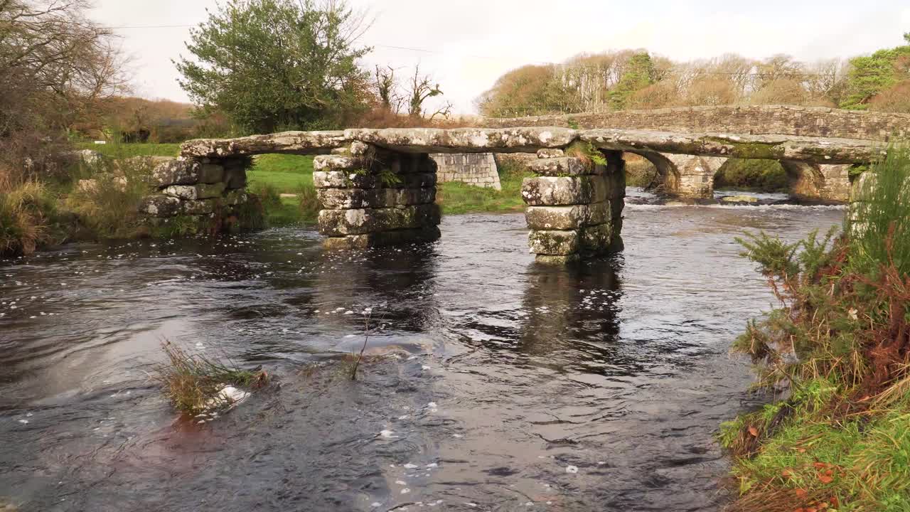 View of bridges of rough stone in the middle of the national park in the English country side with a stream under it