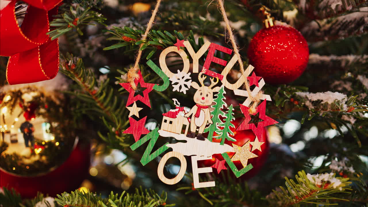 Close up of Christmas decorations and snow on a tree