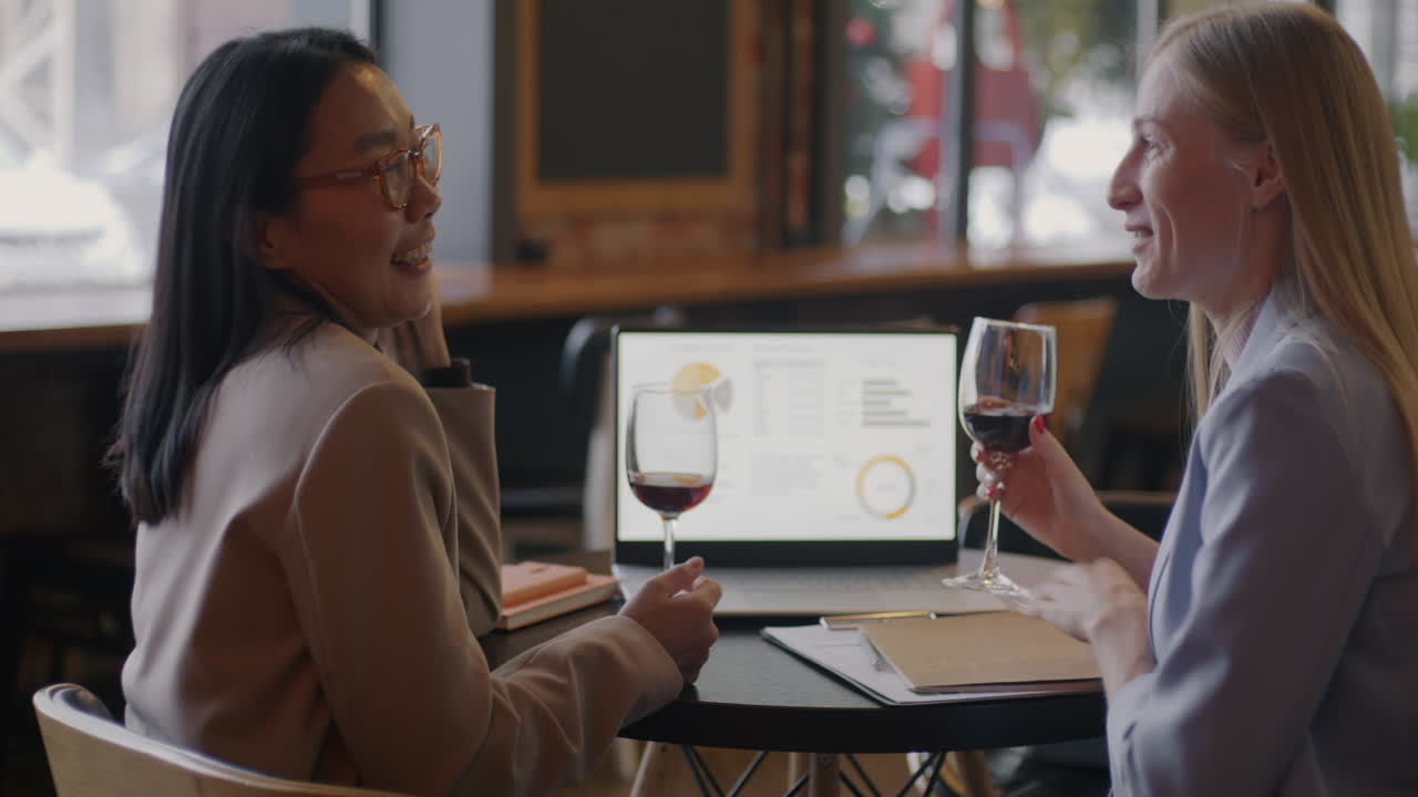 Businesswomen Networking over Wine in a Cafe