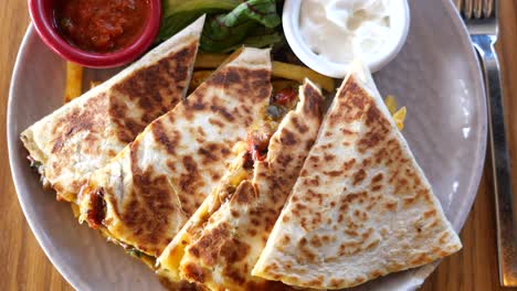 quesadilla with salsa, sour cream, and salad