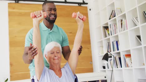 Video-of-african-american-male-physiotherapist-exercising-with-caucasian-senior-woman