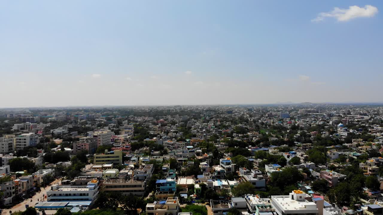 Drone panoramic pullback above Antapur cityscape with clustered homes and long road corridors