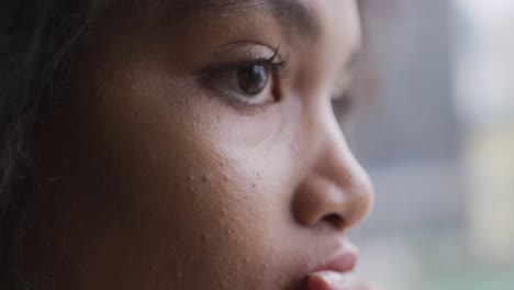 Close-up-view-of-mixed-race-woman-looking-away