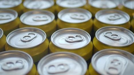 close up of a stack of yellow aluminum cans