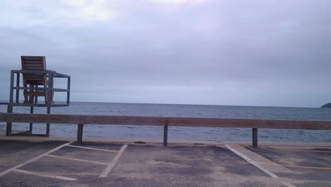 empty chair seaside waterfront looking at the ocean