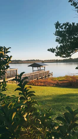 peaceful lakeside dock at dawn/dusk