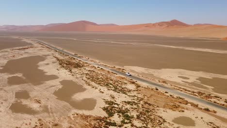 Namibian-self-drive-wildlife-adventure-with-a-rooftop-tent-equipped-Toyota-Hilux-in-Sossusvlei's-iconic-sand-dunes-at-sunset