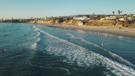 san diego surfers at pacific beach - what to do in san diego - highlights - california coastline - 4k aerial footage