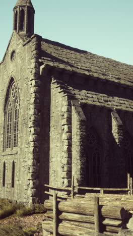 stone church with a tower and arched windows