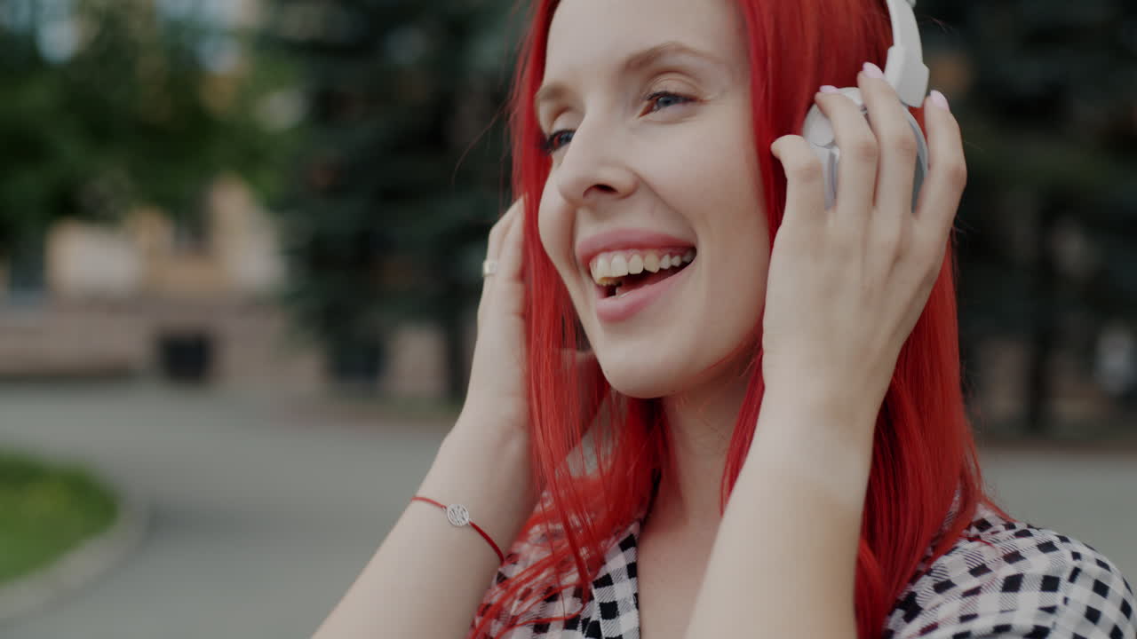 Woman with headphones enjoying music in the park