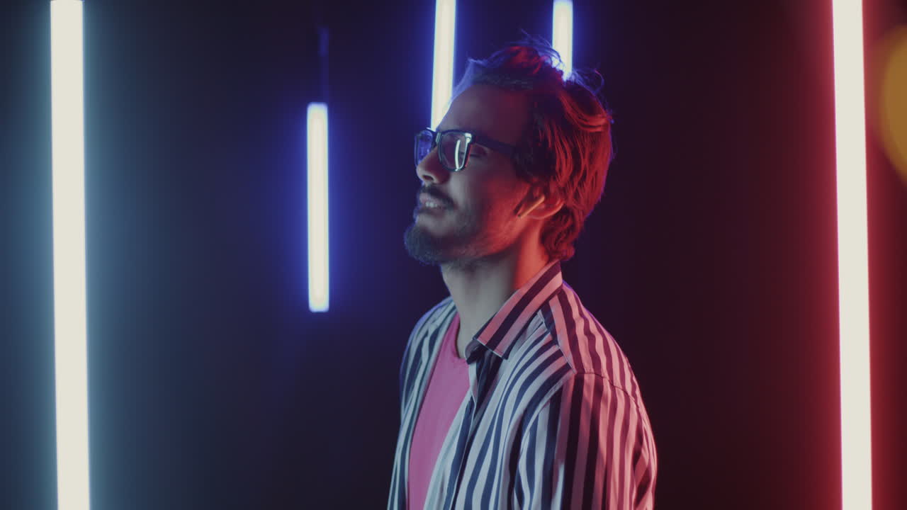 Man Listening to Music with Neon Lights