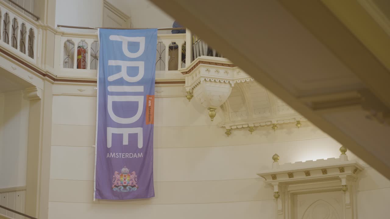 Pride Amsterdam banner hanging inside a churchr. Symbol of inclusion and LGBTQ+ visibility within traditional spaces.