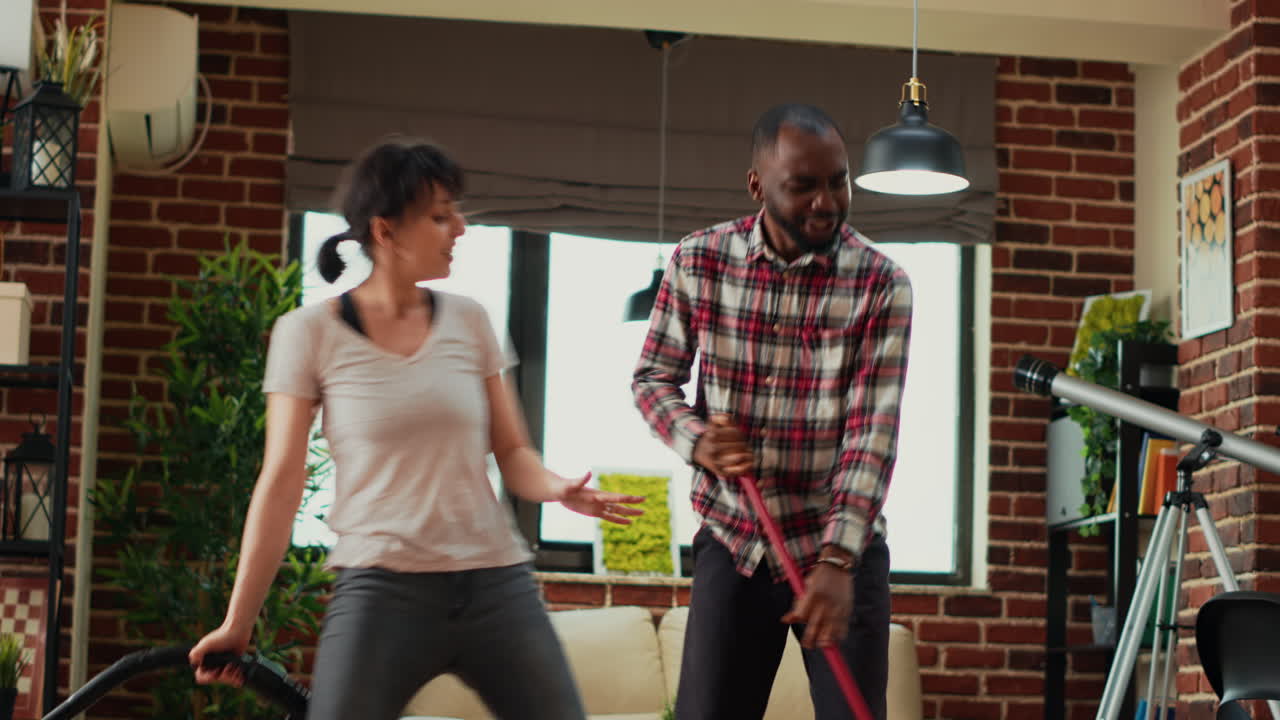 Diverse life partners dancing and singing with appliances