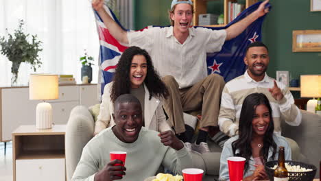 group of friends celebrating a win with the new zealand flag