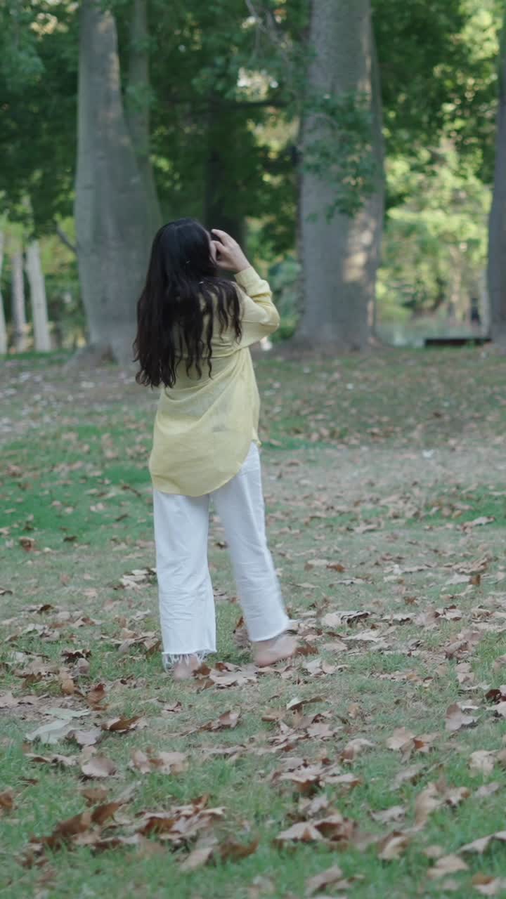 Woman walking barefoot in a park