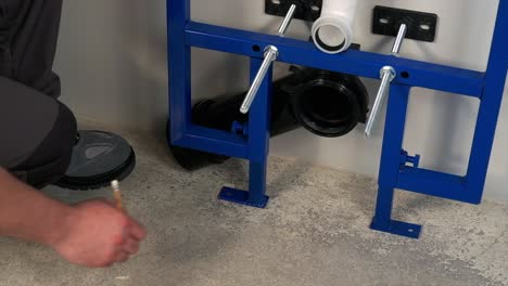 the worker who repairs and installs the toilet bowl and flush uses tools such as pliers and spanners