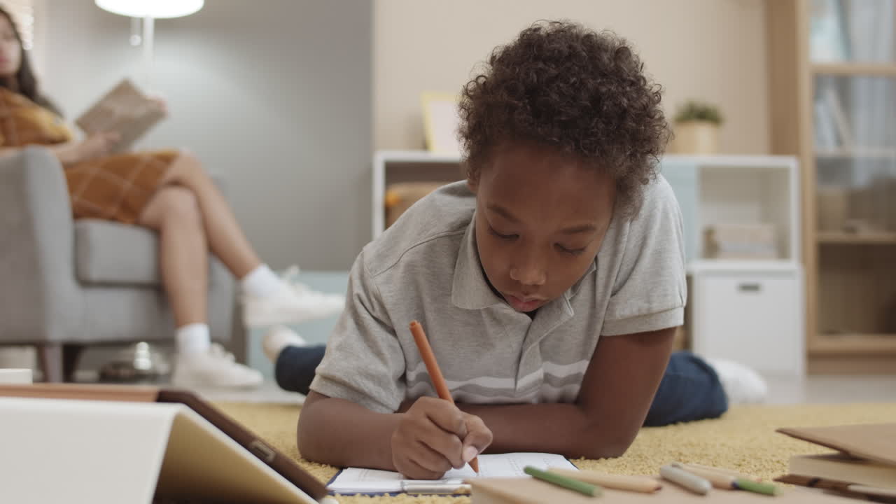 Child Doing Homework on the Floor