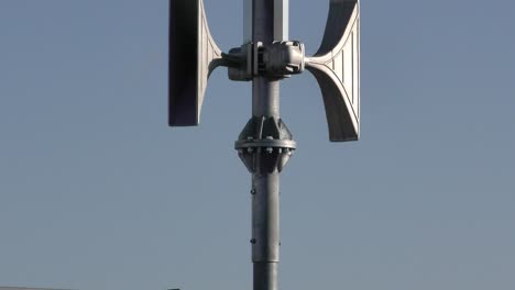 Detail-shot-on-group-of-white-emergency-sirens-on-the-pole-mounted-to-the-roof-durig-the-sunny-day