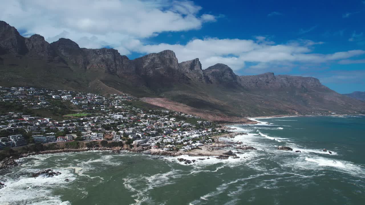Drone shot of Cape Town South Africa from Camps Bay Beach with Twelve Apostles Mountain Range background