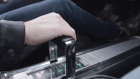 Close-Up-on-gear-shift-of-classic-car-as-man-presses-the-pedals