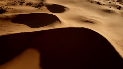 a top-down drone capture of pink dunes reveals rich colors and natural abstract designs in southern utah.