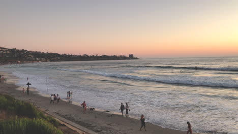 scripps beach sunset with people and surfers in la jolla california