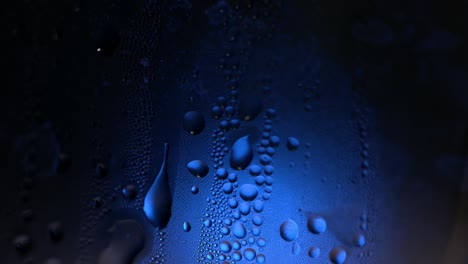 water droplets on glass with blue light