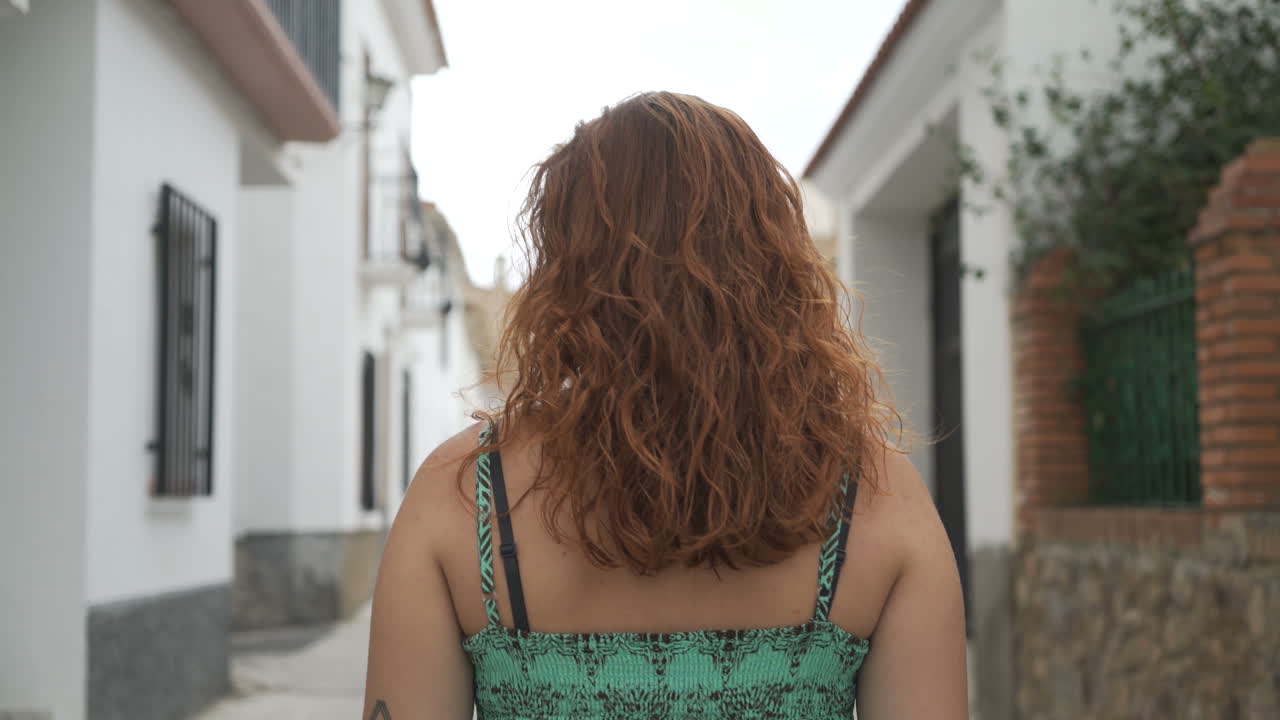 Woman walking down an alley