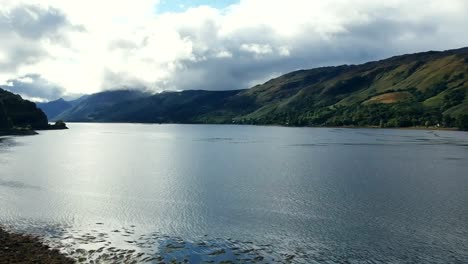 aerial dolly over a loch in the scottish highlands showing the stunning scenery
