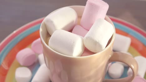 marshmallow in a cup on a plate rotates close up