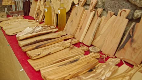 display of beautiful wooden cutting boards in local market, dolly backward shot