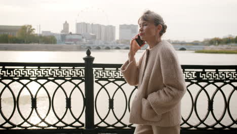 senior woman talking on phone outdoors