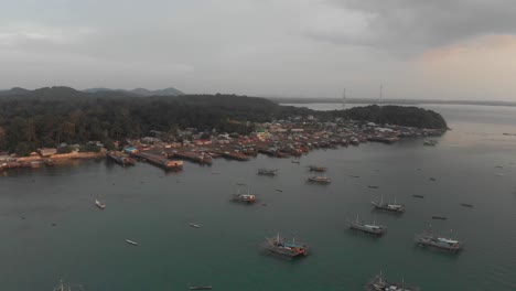 wide view of tanjung binga fishing village at belitung during sunset, aerial