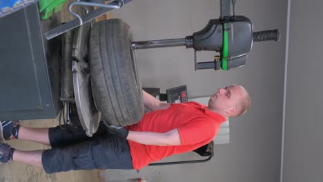 man working on tire change at an auto repair shop