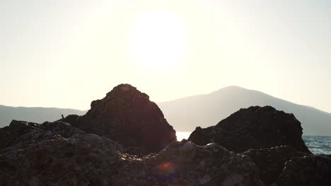 Close-up-of-the-rock-on-the-Albanian-beach-being-shattered-by-the-foamy-waves-of-the-Ionian-Sea