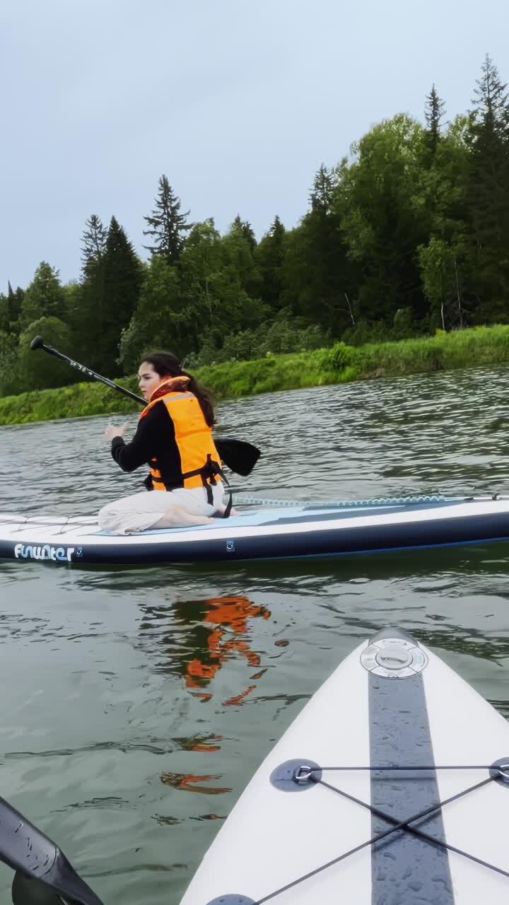 Woman enjoying a paddleboarding session on a lake